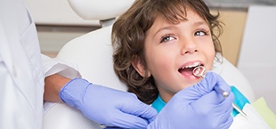 child being examined by the dentist